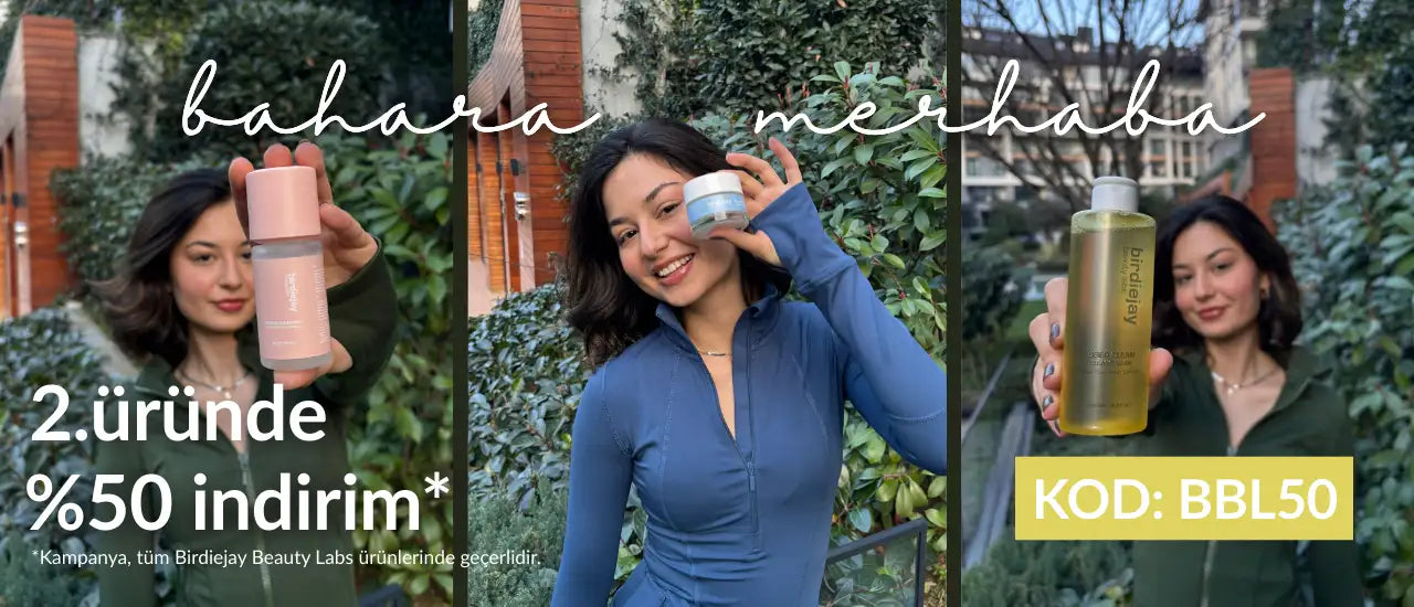 Gümüş kapaklı ve minimalist tasarımlı şık, silindirik pembe bir şişe.