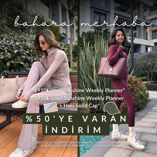 Yuvarlak üstü ve tek dairesel metal mandalı taupe deri bir tote çantası.